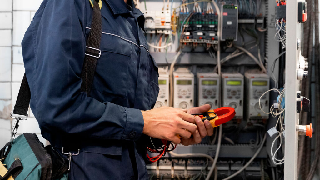 technician working on a hub of sensors